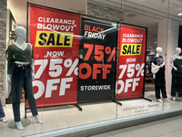 Signs for Black Friday sales are in stores at a shopping mall in Toronto, Ontario, Canada, on November 26, 2024 (