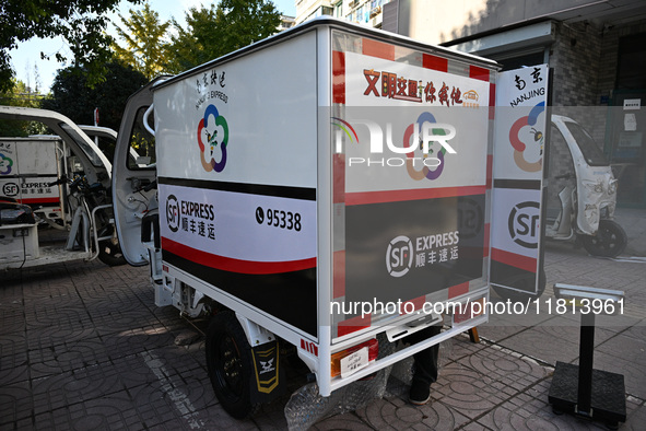 An express delivery vehicle is at the gate of an SF Express station in Nanjing, China, on November 27, 2024. 