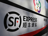 An express delivery vehicle is at the gate of an SF Express station in Nanjing, China, on November 27, 2024. (