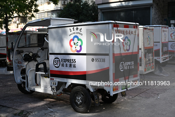 An express delivery vehicle is at the gate of an SF Express station in Nanjing, China, on November 27, 2024. 