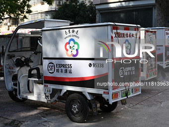 An express delivery vehicle is at the gate of an SF Express station in Nanjing, China, on November 27, 2024. (