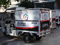 An express delivery vehicle is at the gate of an SF Express station in Nanjing, China, on November 27, 2024. (