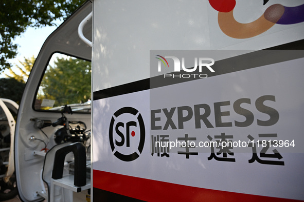 An express delivery vehicle is at the gate of an SF Express station in Nanjing, China, on November 27, 2024. 