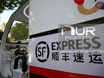 An express delivery vehicle is at the gate of an SF Express station in Nanjing, China, on November 27, 2024. (