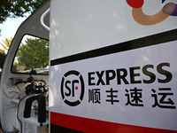 An express delivery vehicle is at the gate of an SF Express station in Nanjing, China, on November 27, 2024. (