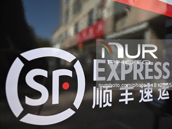 An express delivery vehicle is at the gate of an SF Express station in Nanjing, China, on November 27, 2024. (