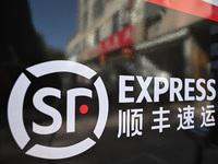 An express delivery vehicle is at the gate of an SF Express station in Nanjing, China, on November 27, 2024. (