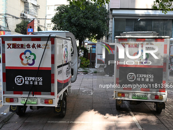 An express delivery vehicle is at the gate of an SF Express station in Nanjing, China, on November 27, 2024. (