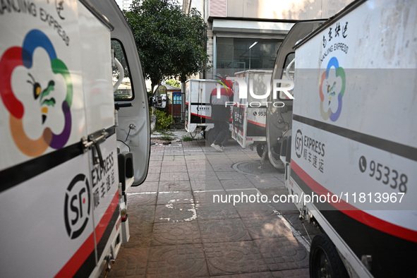 An express delivery vehicle is at the gate of an SF Express station in Nanjing, China, on November 27, 2024. 