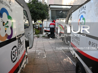 An express delivery vehicle is at the gate of an SF Express station in Nanjing, China, on November 27, 2024. (