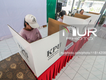 Inmates participate in the simultaneous regional election at a polling station in a prison in Semarang, Central Java Province, on November 2...