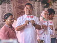 People participate in the simultaneous regional election at a polling station in Semarang, Central Java Province, on November 27, 2024. Indo...