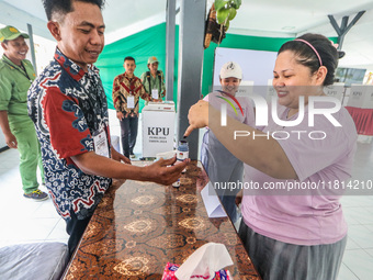 Inmates participate in the simultaneous regional election at a polling station in a prison in Semarang, Central Java Province, on November 2...