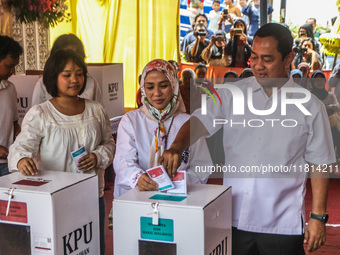 People participate in the simultaneous regional election at a polling station in Semarang, Central Java Province, on November 27, 2024. Indo...