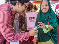 People participate in the simultaneous regional election at a polling station in Semarang, Central Java Province, on November 27, 2024. Indo...