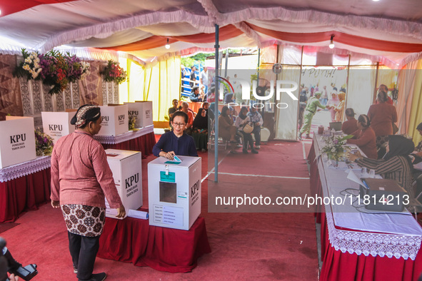 People participate in the simultaneous regional election at a polling station in Semarang, Central Java Province, on November 27, 2024. Indo...