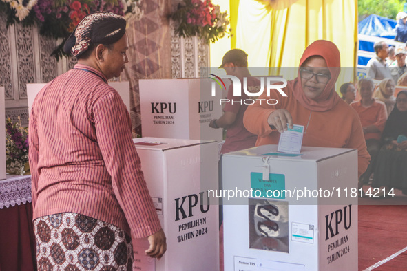 People participate in the simultaneous regional election at a polling station in Semarang, Central Java Province, on November 27, 2024. Indo...