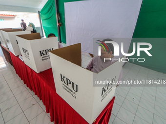 Inmates participate in the simultaneous regional election at a polling station in a prison in Semarang, Central Java Province, on November 2...