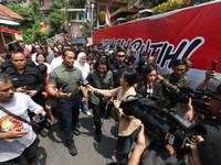 Central Java Province's gubernatorial candidate and former TNI Commander General Andika Perkasa shows the ballot papers while voting at a si...