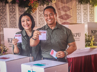 Central Java Province's gubernatorial candidate and former TNI Commander General Andika Perkasa shows the ballot papers while voting at a si...