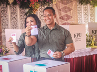 Central Java Province's gubernatorial candidate and former TNI Commander General Andika Perkasa shows the ballot papers while voting at a si...