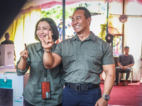 Central Java Province's gubernatorial candidate and former TNI Commander General Andika Perkasa shows the ballot papers while voting at a si...