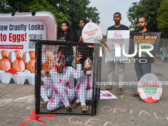 Activists of Mercy for Animals India wear chicken costumes during a protest demonstration against the use and consumption of eggs and to spr...