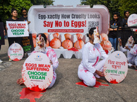 Activists of Mercy for Animals India wear chicken costumes during a protest demonstration against the use and consumption of eggs and to spr...