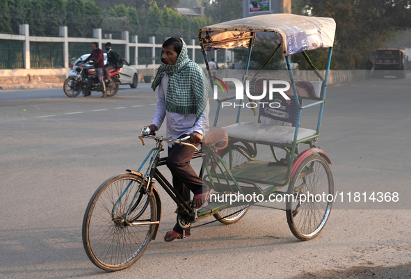 A rickshaw puller covers his face with a scarf as air pollution levels remain in the ''very poor'' category in New Delhi, India, on November...