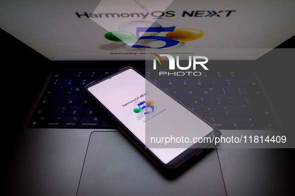 The logo of the Huawei HarmonyOS NEXT operating system appears on a smartphone screen and on a computer screen as a background in this photo...