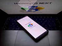 The logo of the Huawei HarmonyOS NEXT operating system appears on a smartphone screen and on a computer screen as a background in this photo...