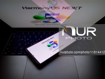 The logo of the Huawei HarmonyOS NEXT operating system appears on a smartphone screen and on a computer screen as a background in this photo...