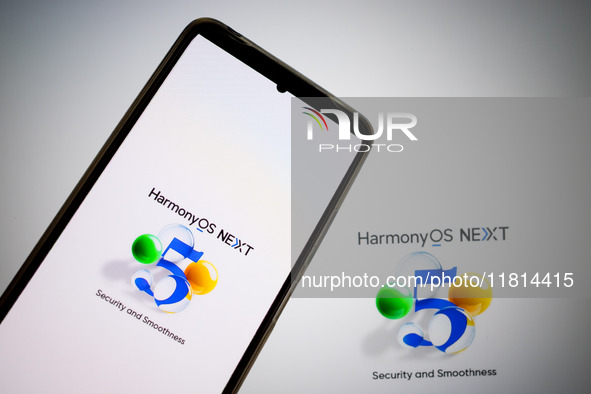 The logo of the Huawei HarmonyOS NEXT operating system appears on a smartphone screen and on a computer screen as a background in this photo...