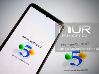 The logo of the Huawei HarmonyOS NEXT operating system appears on a smartphone screen and on a computer screen as a background in this photo...