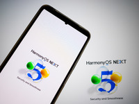 The logo of the Huawei HarmonyOS NEXT operating system appears on a smartphone screen and on a computer screen as a background in this photo...