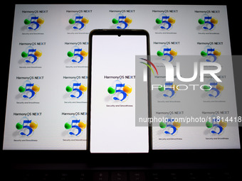 The logo of the Huawei HarmonyOS NEXT operating system appears on a smartphone screen and on a computer screen as a background in this photo...