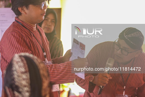 Election staffers count ballots at a polling station in Semarang, Central Java Province, on November 27, 2024, after Indonesians vote to pic...