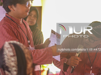 Election staffers count ballots at a polling station in Semarang, Central Java Province, on November 27, 2024, after Indonesians vote to pic...