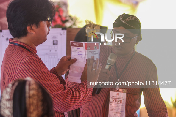 Election staffers count ballots at a polling station in Semarang, Central Java Province, on November 27, 2024, after Indonesians vote to pic...