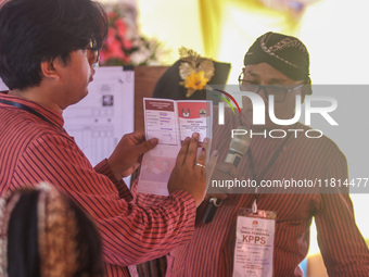 Election staffers count ballots at a polling station in Semarang, Central Java Province, on November 27, 2024, after Indonesians vote to pic...