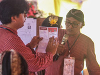 Election staffers count ballots at a polling station in Semarang, Central Java Province, on November 27, 2024, after Indonesians vote to pic...