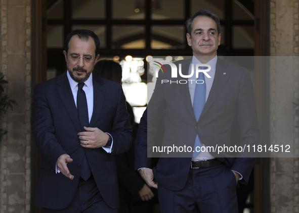 Cyprus' President Nikos Chirstodoulides, left, and Greece's Prime Minister Kyriakos Mitsotakis talk during a meeting at the presidential pal...