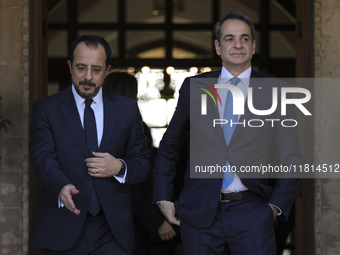 Cyprus' President Nikos Chirstodoulides, left, and Greece's Prime Minister Kyriakos Mitsotakis talk during a meeting at the presidential pal...