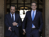 Cyprus' President Nikos Chirstodoulides, left, and Greece's Prime Minister Kyriakos Mitsotakis talk during a meeting at the presidential pal...