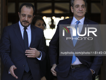 Cyprus' President Nikos Chirstodoulides, left, and Greece's Prime Minister Kyriakos Mitsotakis talk during a meeting at the presidential pal...