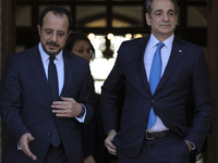 Cyprus' President Nikos Chirstodoulides, left, and Greece's Prime Minister Kyriakos Mitsotakis talk during a meeting at the presidential pal...