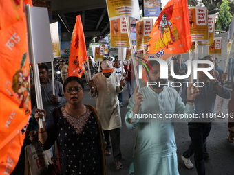 Bharatiya Janata Party (BJP) activists shout slogans and carry placards during a protest rally towards the Bangladesh High Commission in Kol...