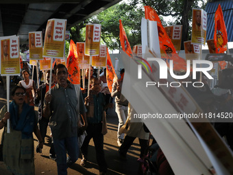 Bharatiya Janata Party (BJP) activists shout slogans and carry placards during a protest rally towards the Bangladesh High Commission in Kol...