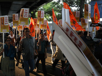 Bharatiya Janata Party (BJP) activists shout slogans and carry placards during a protest rally towards the Bangladesh High Commission in Kol...