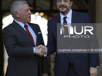 Cyprus' President Nikos Christodoulides, right, and the Jordan's King Abdullah II bin al-Hussein shake hands before a meeting at the Preside...